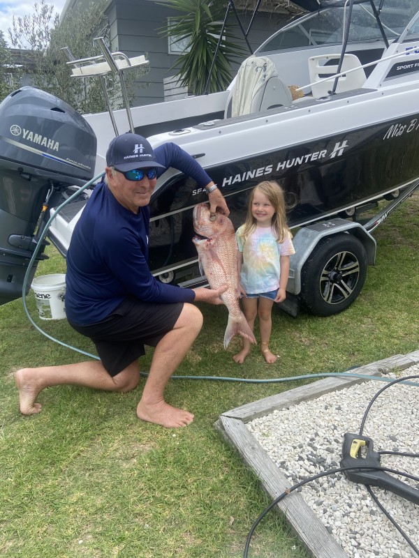 Captain Swish with his granddaughter in front of his Haines Hunter